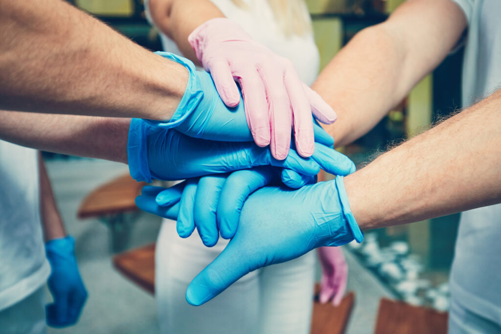 Dental professionals put their surgical-gloved hands in for a 